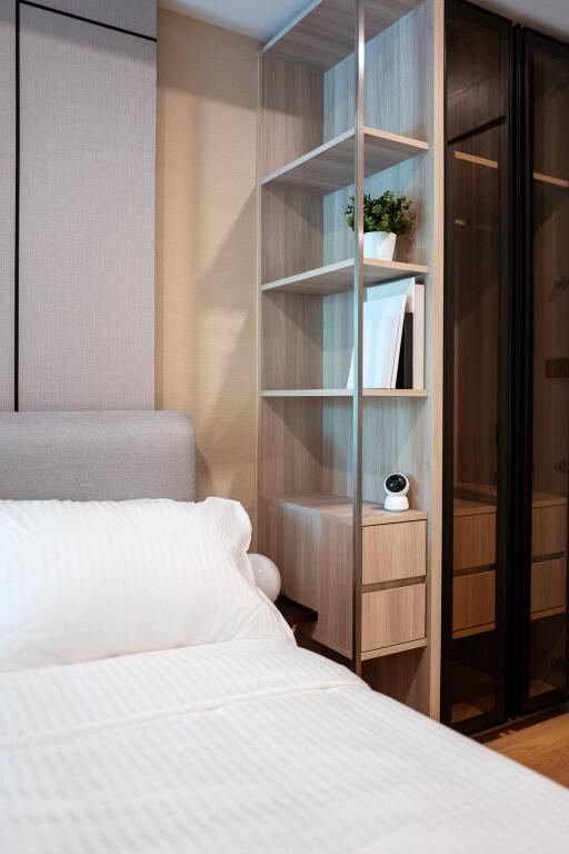 Cozy bedroom with modern shelving unit and sliding wardrobe doors