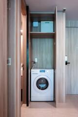 Compact laundry area with a modern washing machine