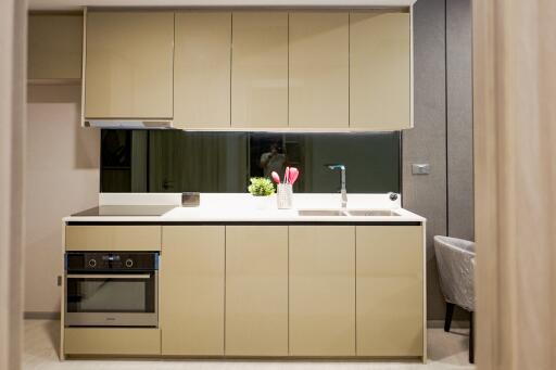 Modern kitchen with built-in appliances and beige cabinetry