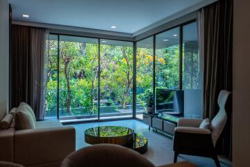 Modern living room with large windows and garden view