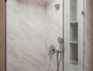 Modern bathroom with a glass shower and marble walls