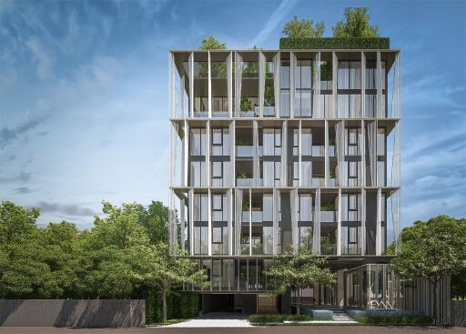 Modern multi-story building exterior with lush green landscaping