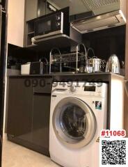 Compact modern kitchen with laundry appliances