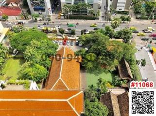 Aerial view of an urban landscape showing buildings, streets, and vegetation