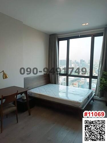 Modern bedroom with large window and city view