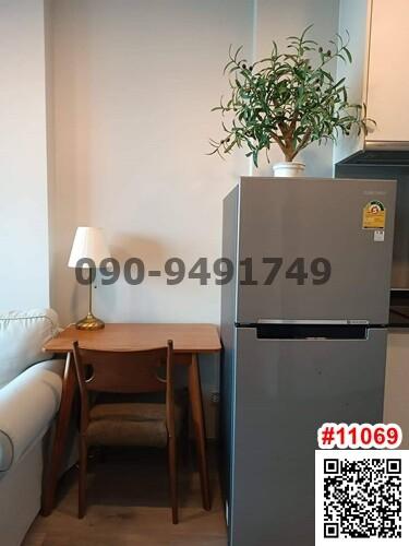 Cozy kitchen area with modern refrigerator and wooden dining table