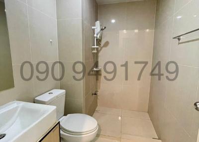 Modern bathroom with white fixtures and tiled walls