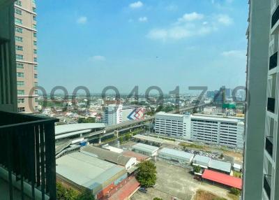 Panoramic city view from high-rise balcony with clear blue sky