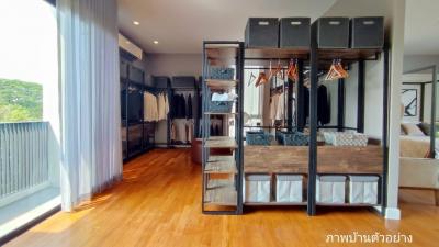 Modern bedroom with walk-in closet and hardwood floors