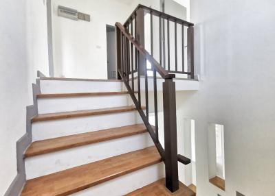 Bright modern staircase with wood accents and air conditioning unit