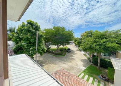 Expansive view from property balcony showing a residential area with clear skies and lush greenery