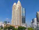 Modern high-rise residential tower amid an urban skyline