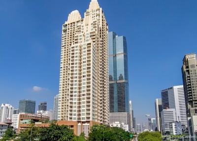 Modern high-rise residential tower amid an urban skyline