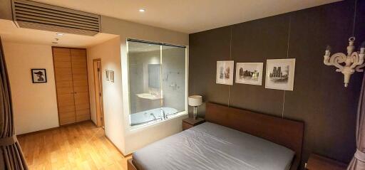 Modern bedroom with en-suite bathroom and aesthetic wall art