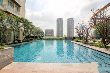 Residential complex with outdoor swimming pool and surrounding skyscrapers