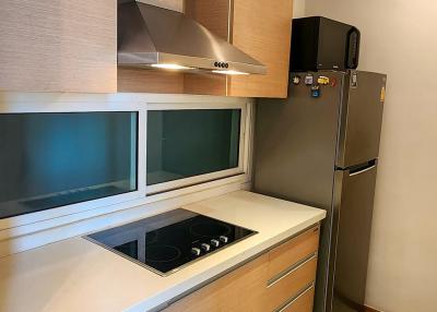 Modern kitchen with built-in appliances and wooden cabinets