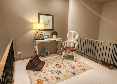 Cozy upstairs hallway with decorative elements and seating area