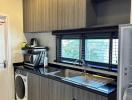 Compact modern kitchen with stainless steel appliances and wooden cabinetry