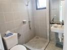 Modern bathroom with glass shower enclosure and tiled walls