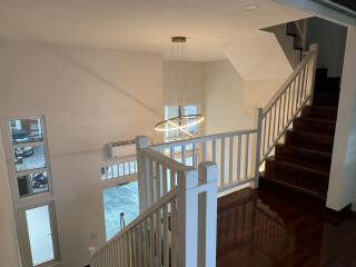 Spacious upstairs hallway with natural lighting and wooden flooring