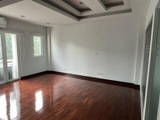 Spacious living room with hardwood floors and ample natural light