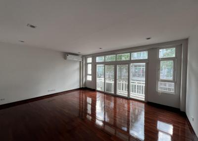 Spacious living room with hardwood floors and ample natural light