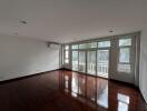 Spacious living room with hardwood floors and ample natural light