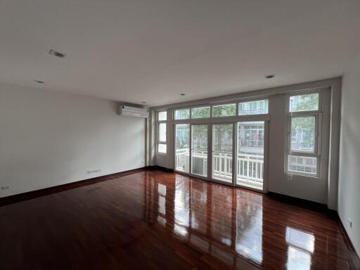 Spacious living room with hardwood floors and ample natural light