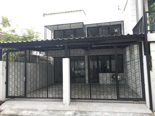 Exterior view of a modern two-story home with glass facade