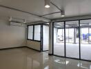 Bright and open commercial space with large glass windows and tiled flooring