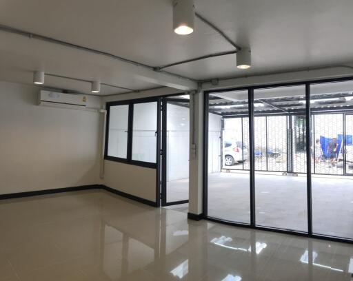 Bright and open commercial space with large glass windows and tiled flooring