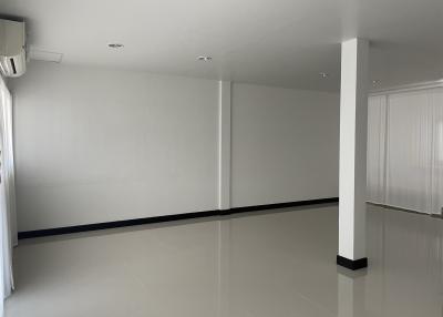 Spacious empty room with glossy floor and white walls