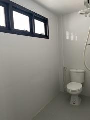 Modern bathroom with white wall tiles and grey floor tiles