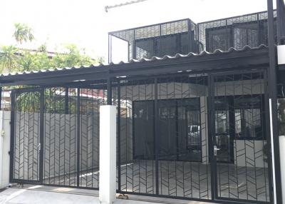 Modern two-story building with black gate and balcony