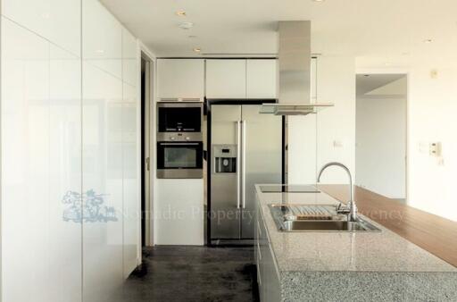 Modern kitchen with stainless steel appliances and white cabinetry