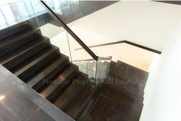 Modern stairway with glass banister inside a contemporary house