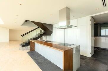 Spacious modern living area with open kitchen and staircase