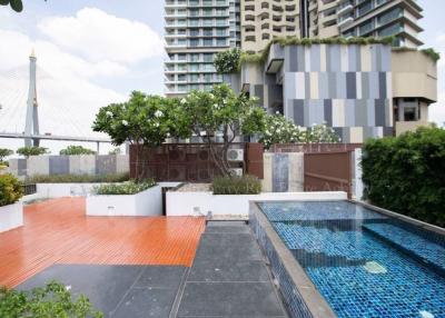 Modern apartment complex outdoor area with pool and garden