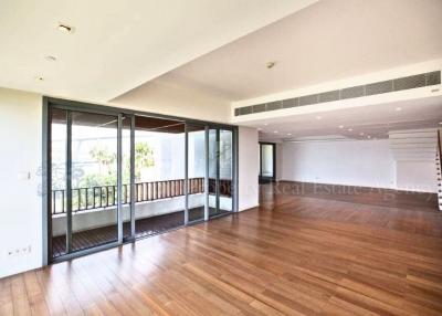 Spacious living room with hardwood floors and abundant natural light