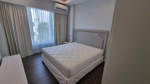 Modern bedroom with large bed and natural light