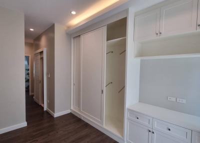 Spacious hallway with built-in storage closets and cabinets