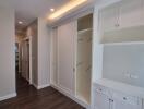 Spacious hallway with built-in storage closets and cabinets