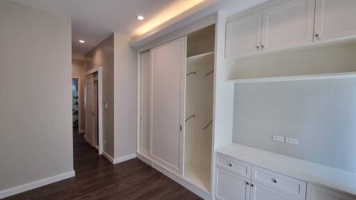 Spacious hallway with built-in storage closets and cabinets