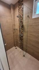 Modern bathroom with walk-in shower and decorative tile wall