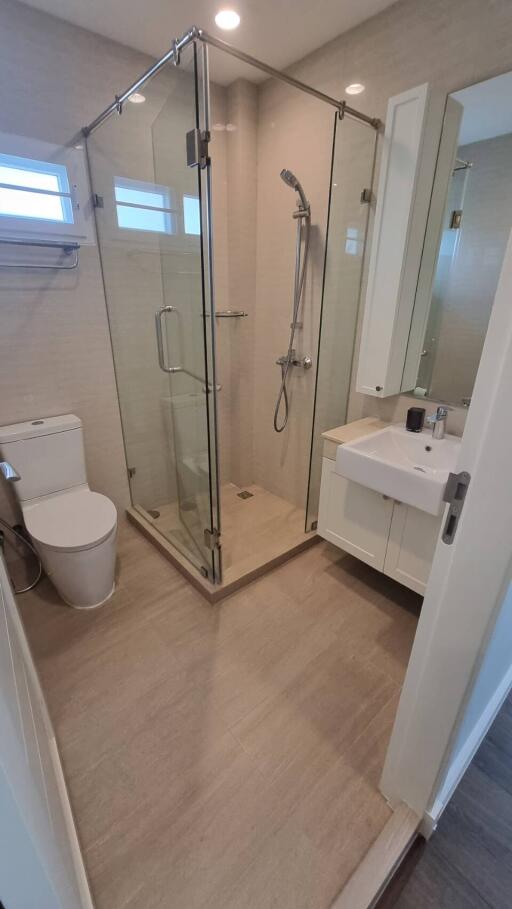 Modern bathroom with walk-in shower and white fixtures