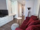 Modern living room with red sofa and flat screen TV