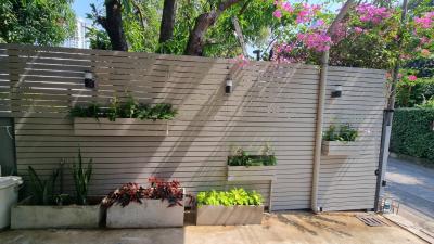 Peaceful outdoor area with a modern slatted fence and planters