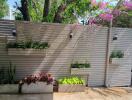 Peaceful outdoor area with a modern slatted fence and planters