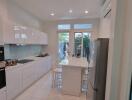 Modern kitchen with white cabinetry and stainless steel appliances