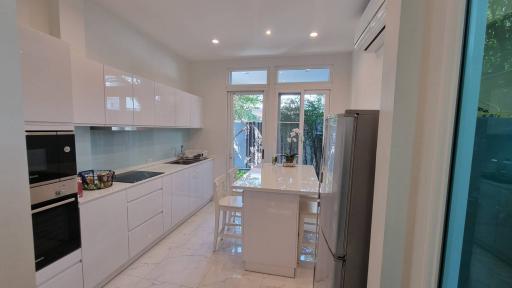 Modern kitchen with white cabinetry and stainless steel appliances